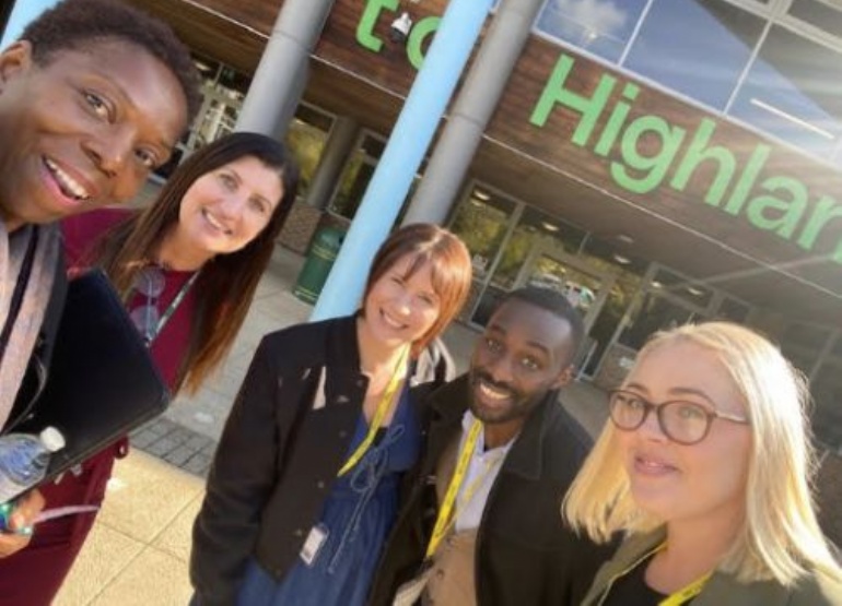 staff and visitors outside school building